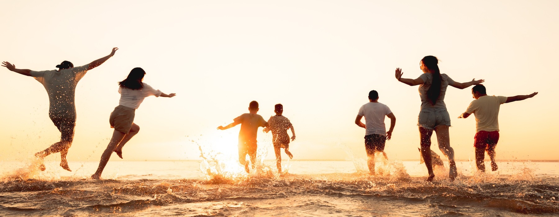 a group of people jumping into the ocean